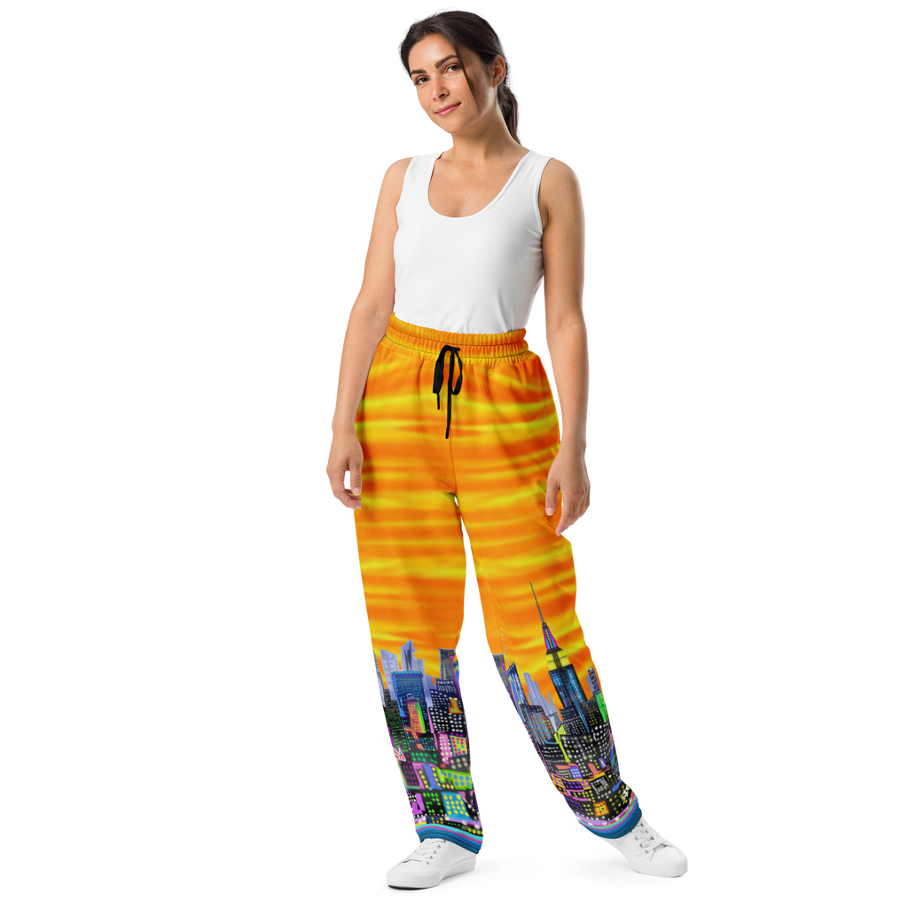 Woman wearing a white tank top and colorful pants with Loria NYC Art cityscape design on a white background