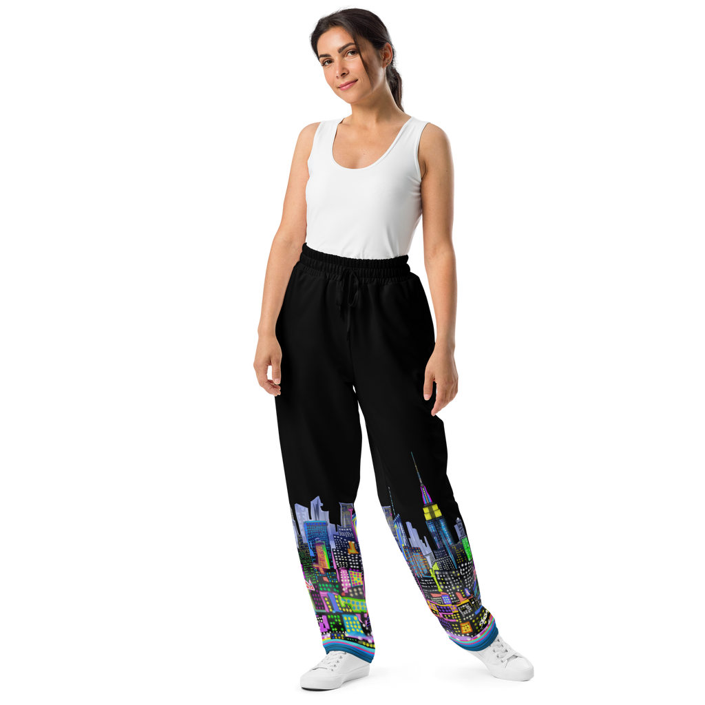 Woman wearing black pants with Loria NYC Art colorful cityscape design on a white background