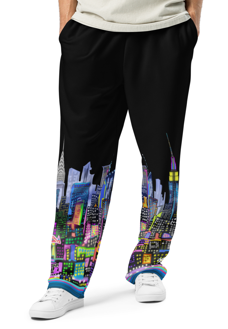 Person wearing a light gray t-shirt and black pants with colorful cityscape Loria NYC Art design on a white background