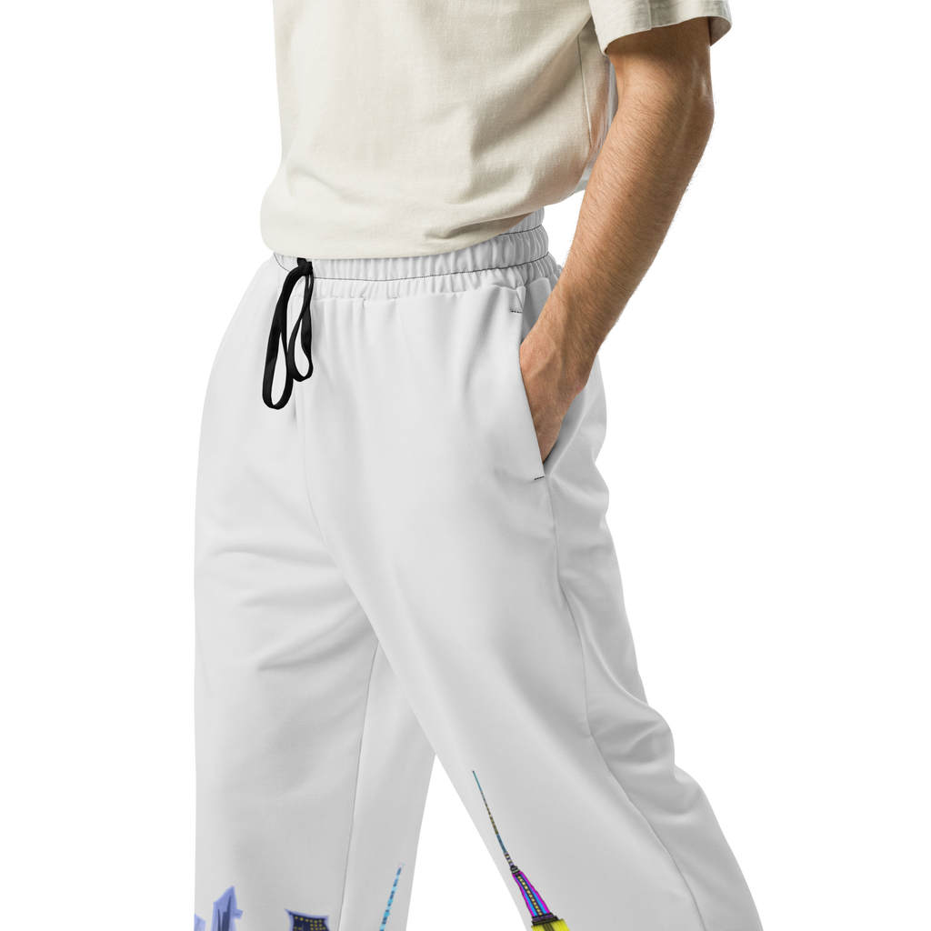 Person wearing light gray Loria NYC Art pants with colorful accents on a white background