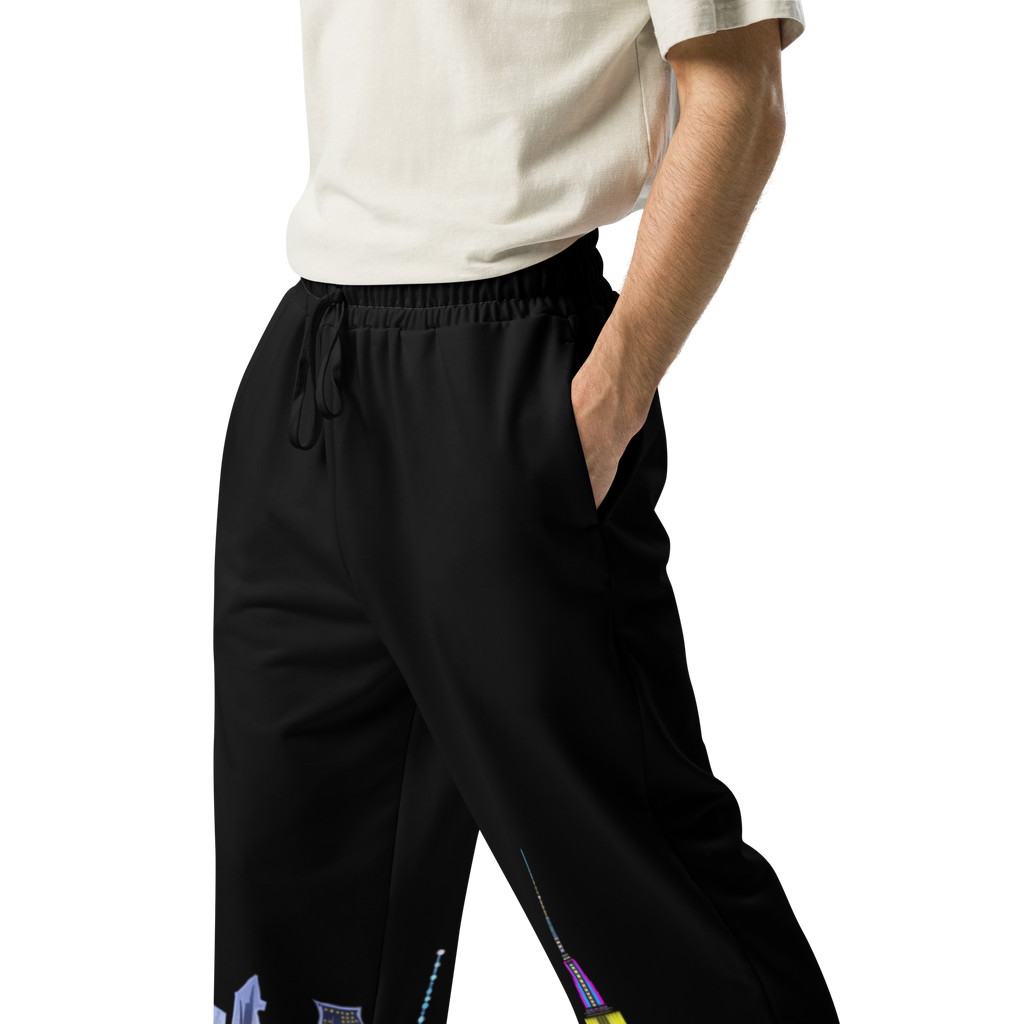 Person wearing black pants with Loria NYC Art colorful accents on a white background