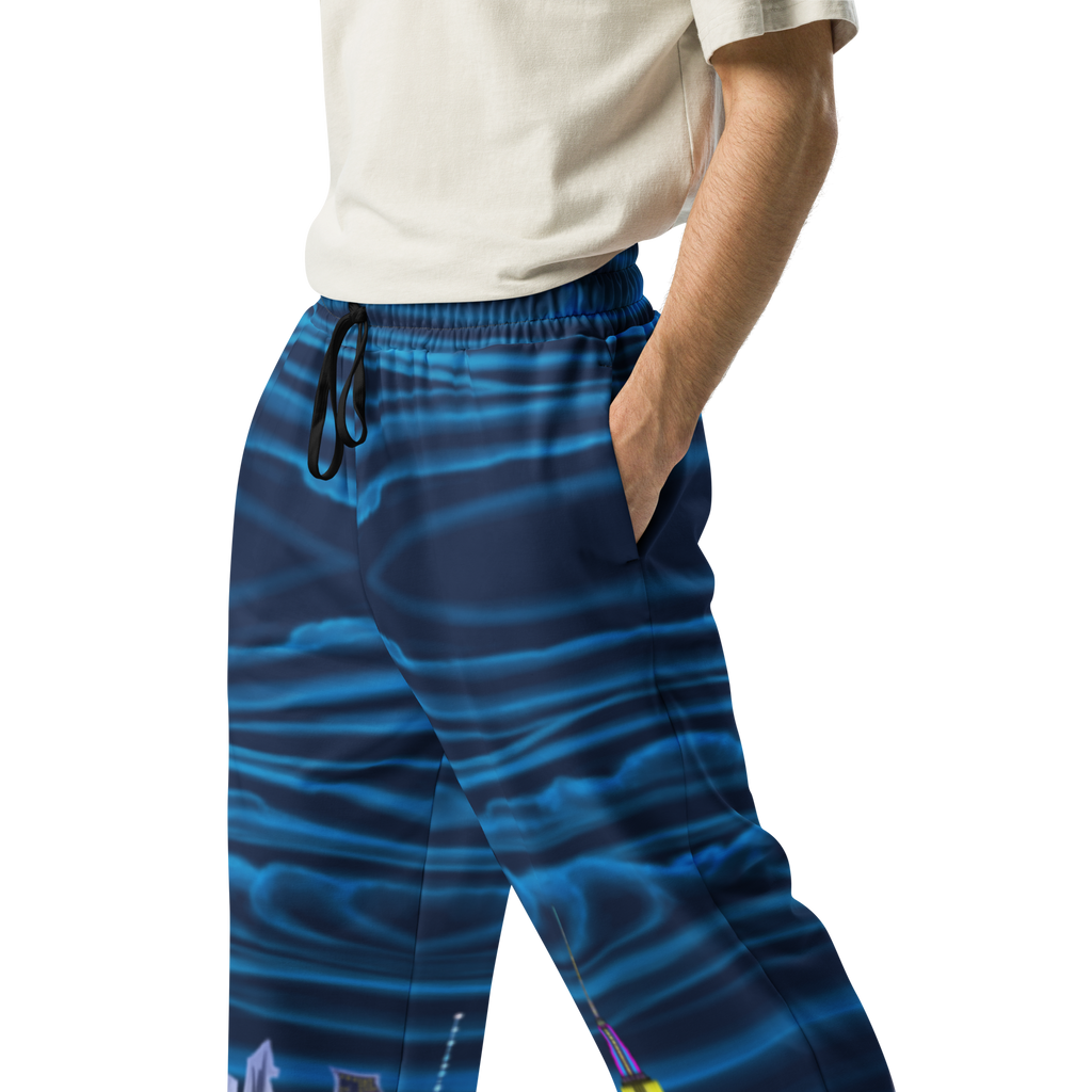 Blue patterned Loria NYC Art pants worn by a person on a white background