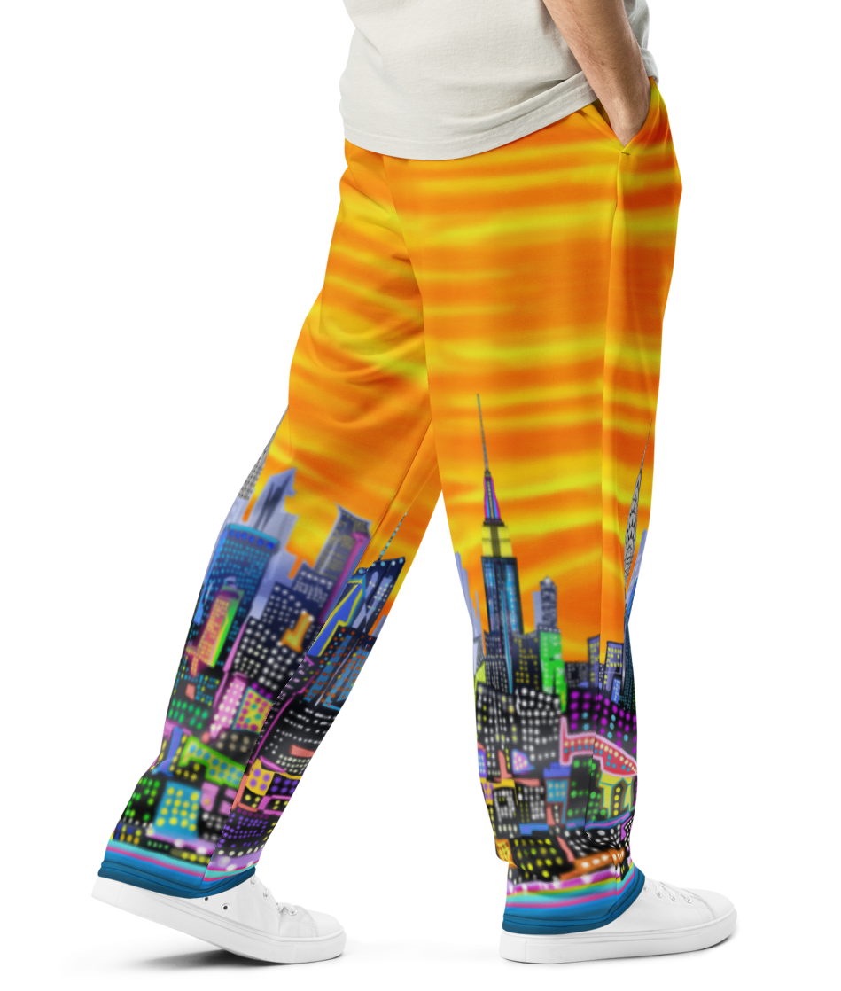 Person wearing colorful Loria NYC Art pants with a cityscape design on a white background