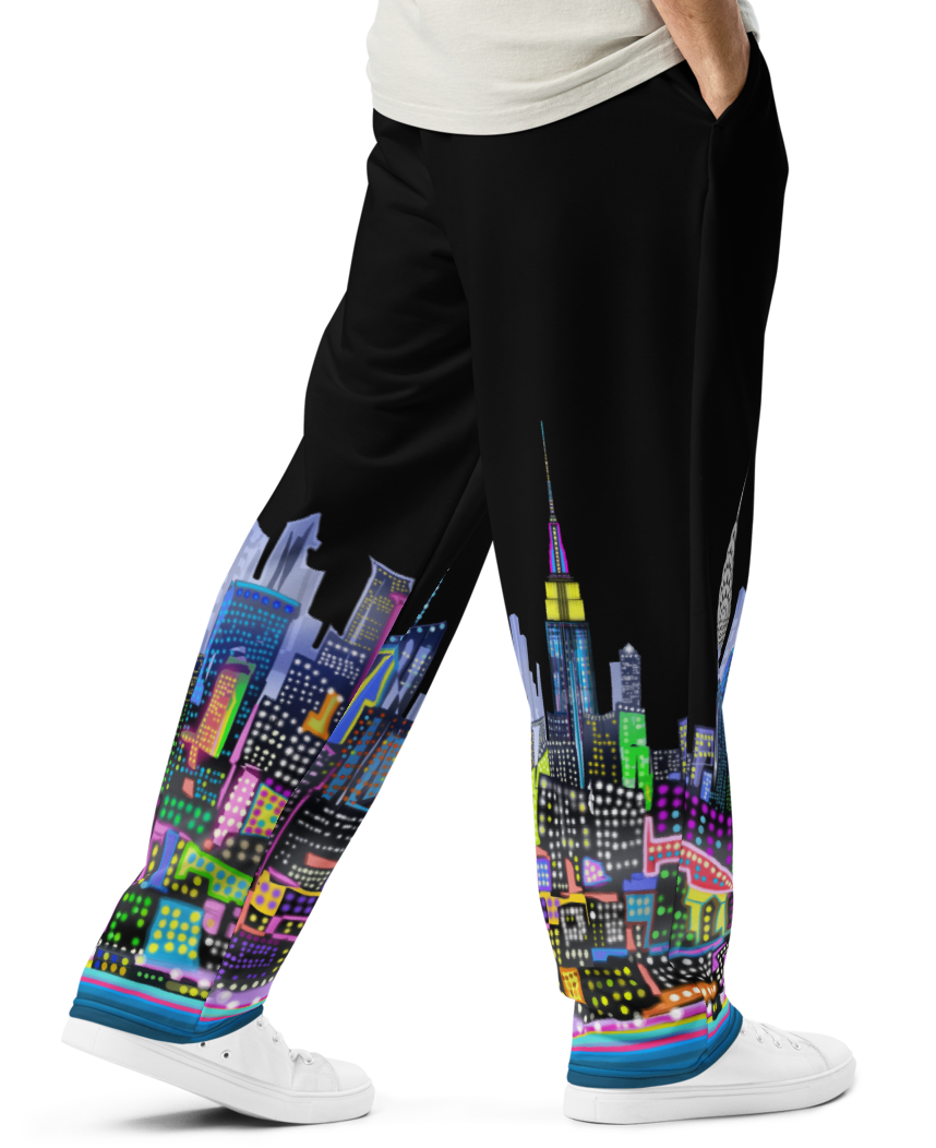 Man wearing a white t-shirt and black pants with Loria NYC Art colorful cityscape design on a white background