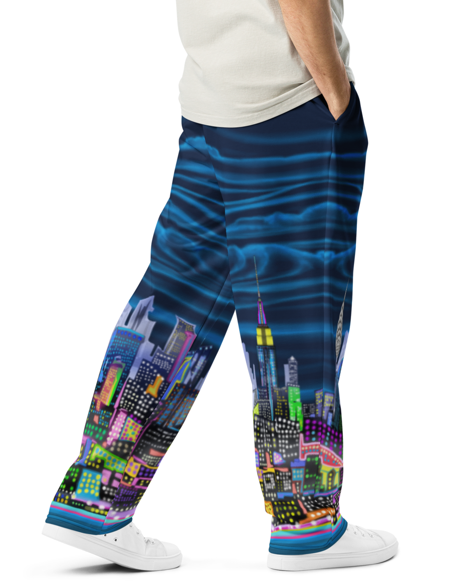 Man wearing a white t-shirt and colorful Loria NYC Art pants on a white background