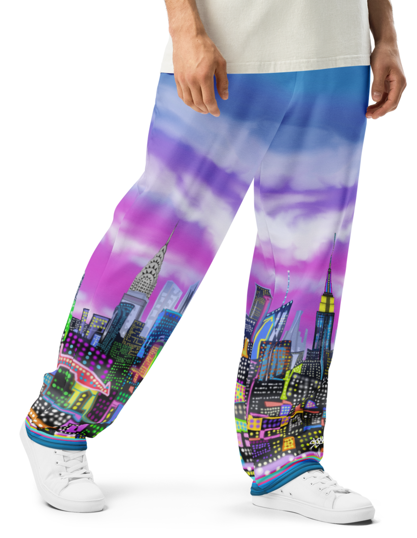 Person wearing a white t-shirt and colorful pants with cityscape Loria NYC Art design on a white background
