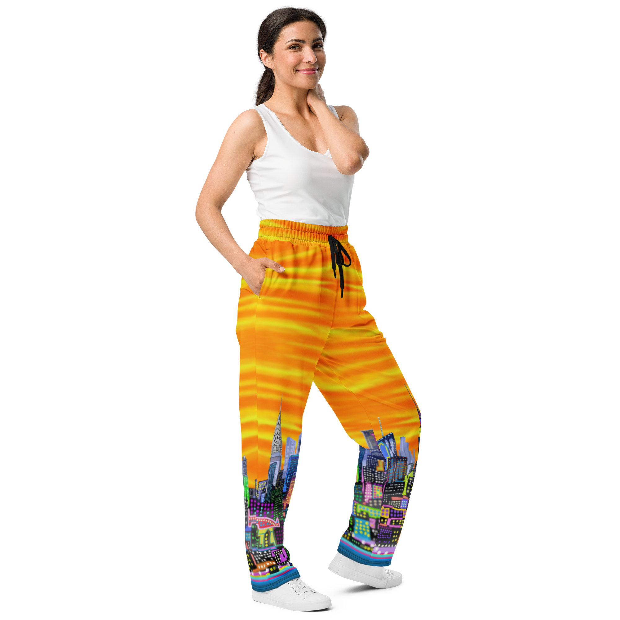 Woman wearing colorful pants with a Loria NYC Art cityscape design on a white background