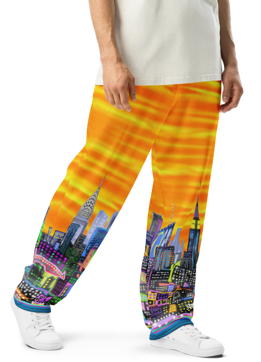Person wearing colorful Loria NYC Art pants with a cityscape design on a white background