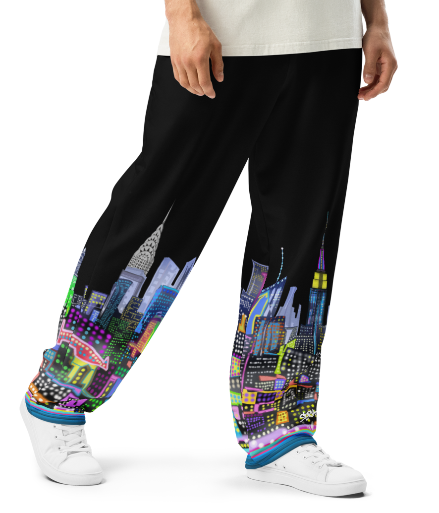 Person wearing a white t-shirt and black pants with colorful Loria NYC Art cityscape design on a white background