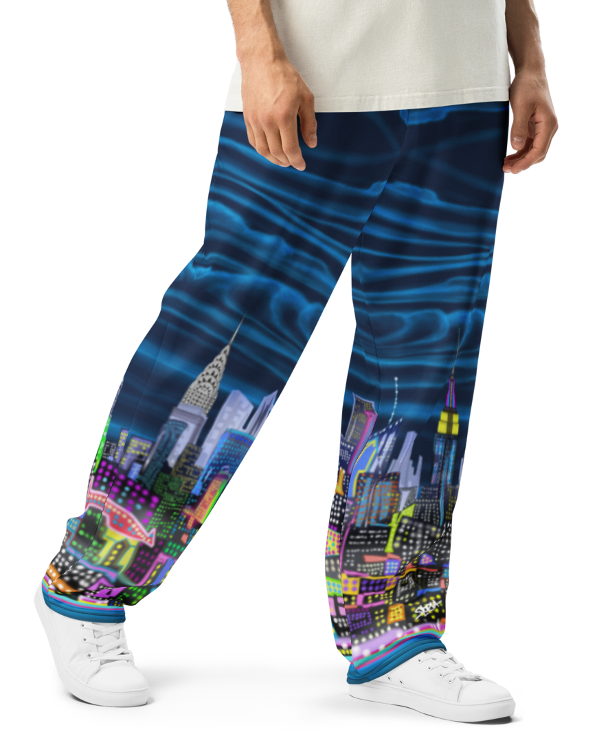 Person wearing a white t-shirt and colorful pants with cityscape Loria NYC Art design on a white background