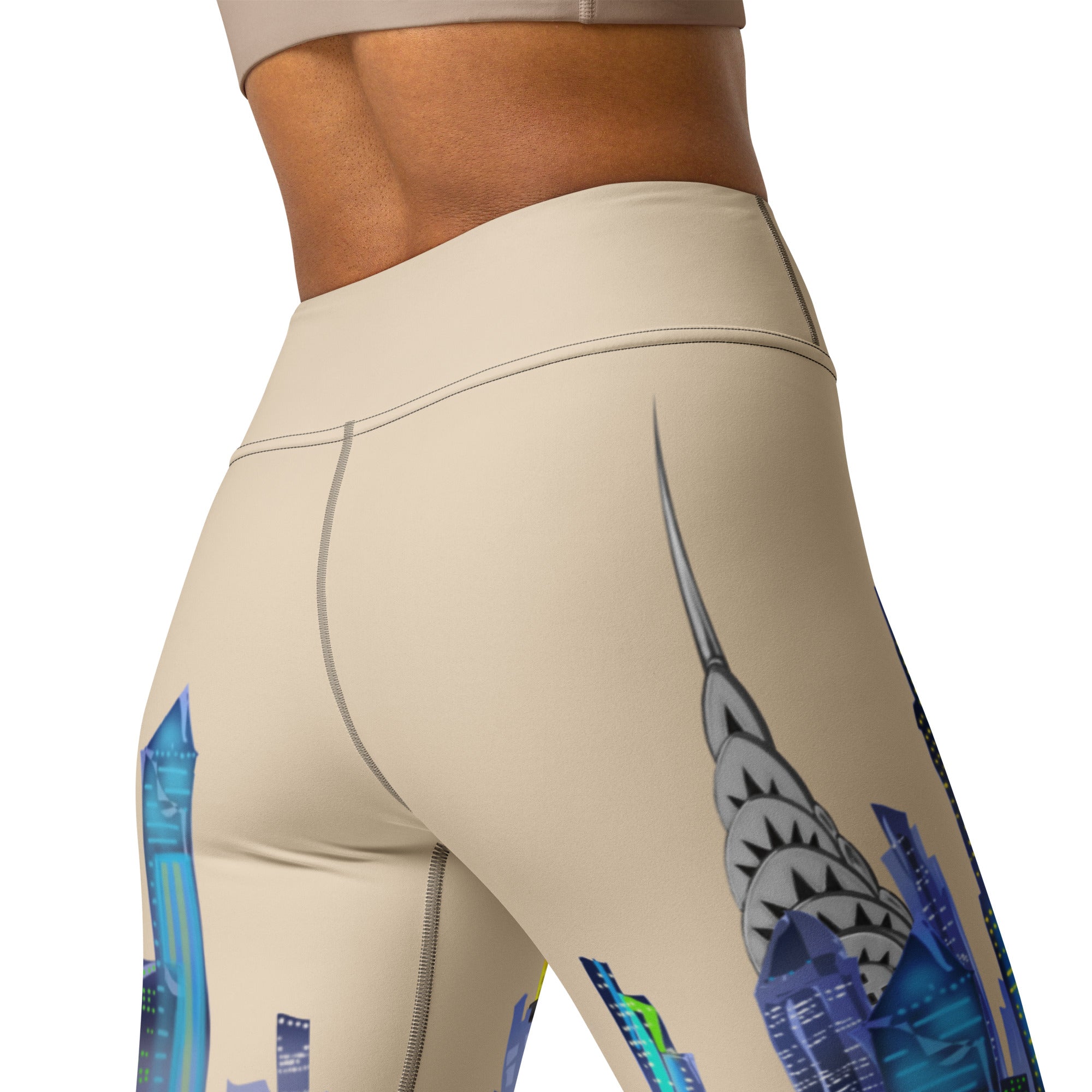 Beige leggings with colorful Loria NYC Art geometric designs on a white background