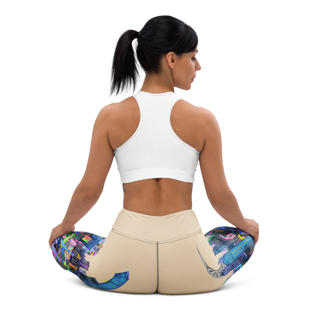 Woman wearing Loria NYC Art yoga pants  sitting down on a with a white background