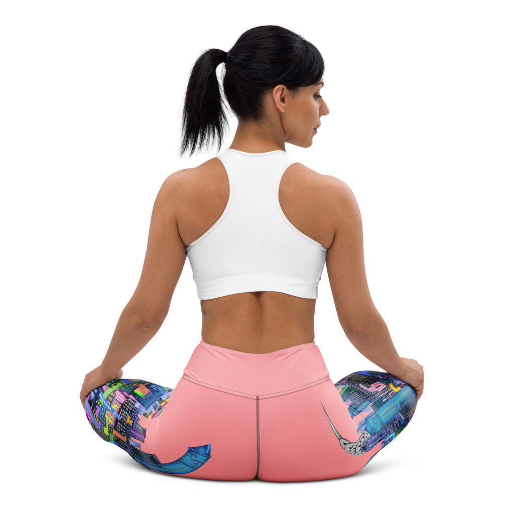 Woman sitting down wearing pink Loria NYC Art leggings with a white background