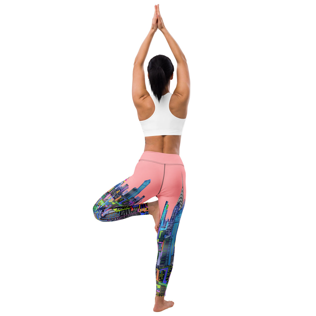Person wearing colorful Loria NYC Art leggings and a white sports bra, standing with hands pressed together above head on a white background.