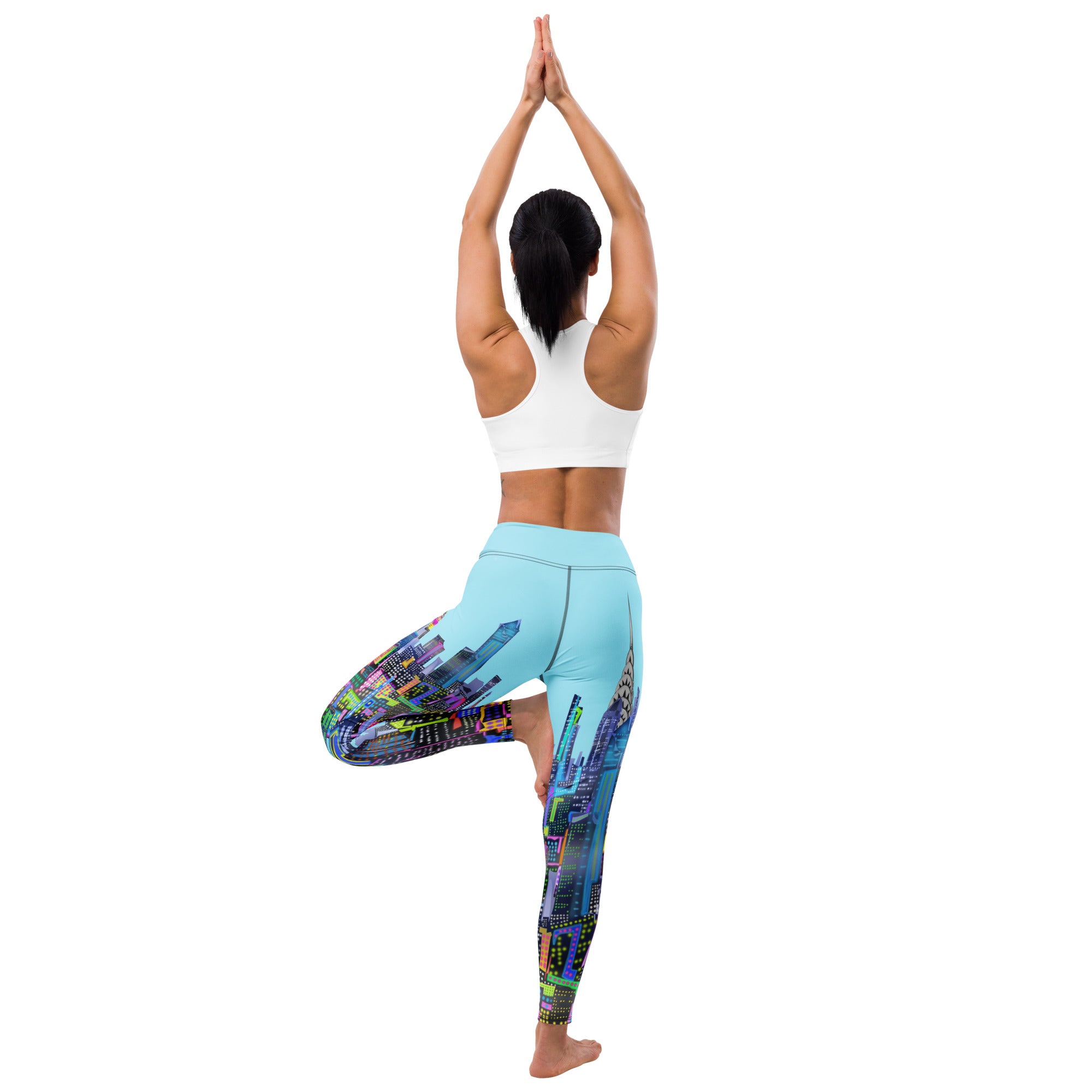 Person wearing colorful leggings with a Loria NYC Art cityscape design on a white background