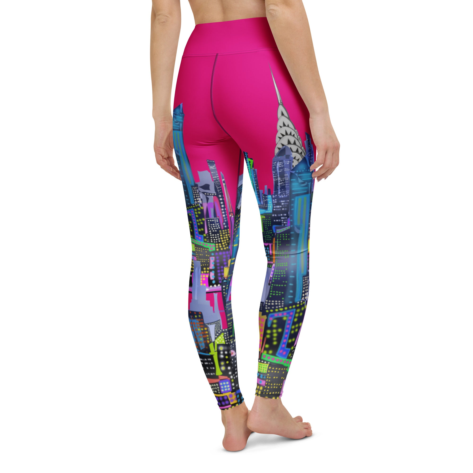 Person wearing Loria NYC Art fuchsia leggings with a colorful cityscape pattern on a white background