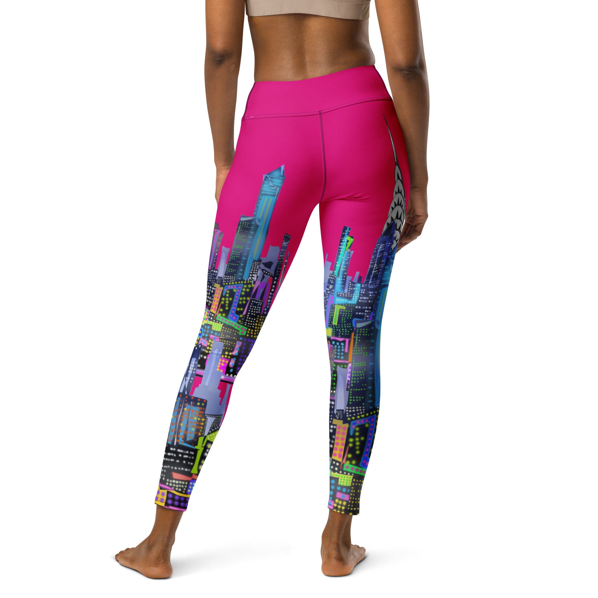 Person wearing pink leggings with a Loria NYC Art colorful cityscape design on a white background