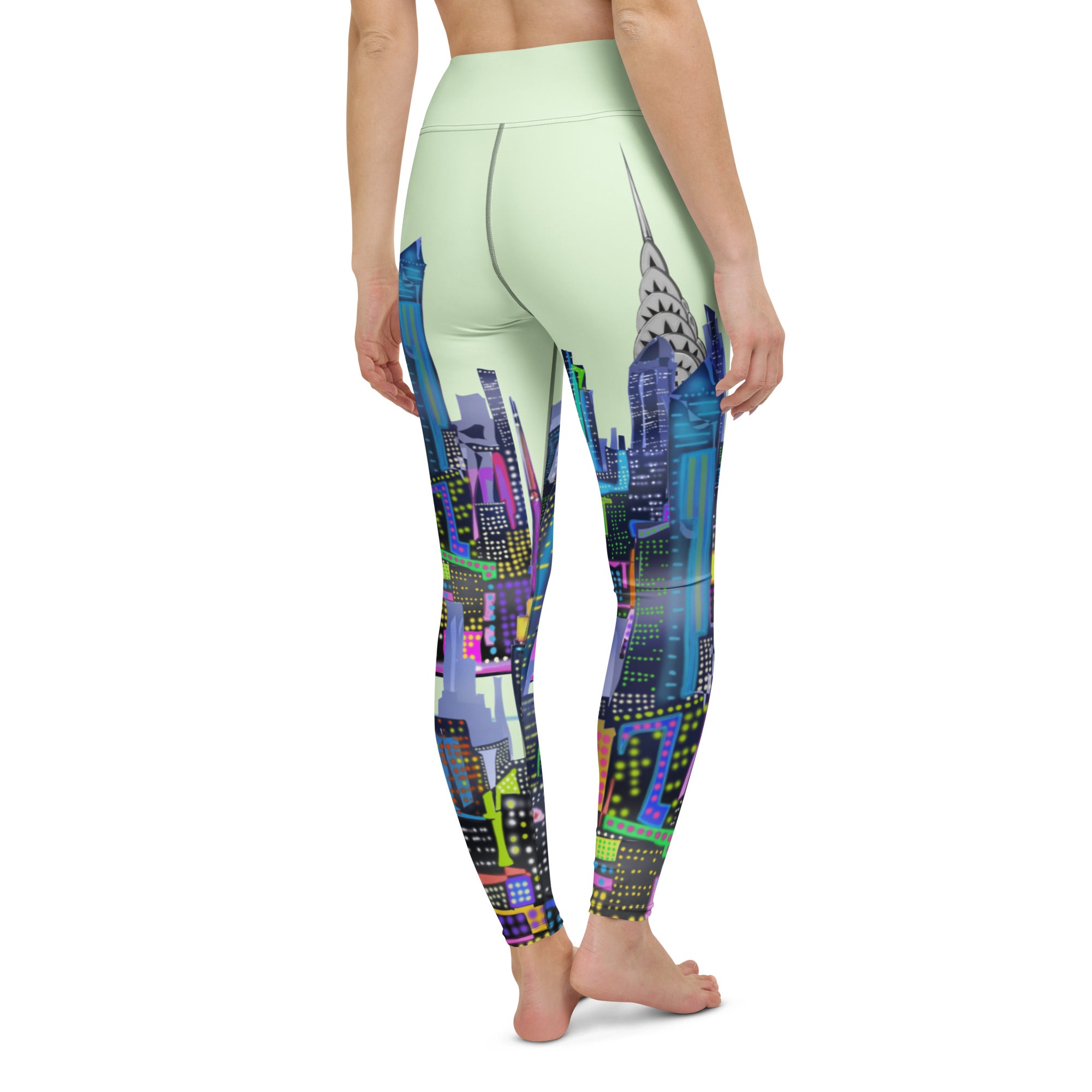 Leggings with a colorful green Loria NYC Art cityscape design on a white background
