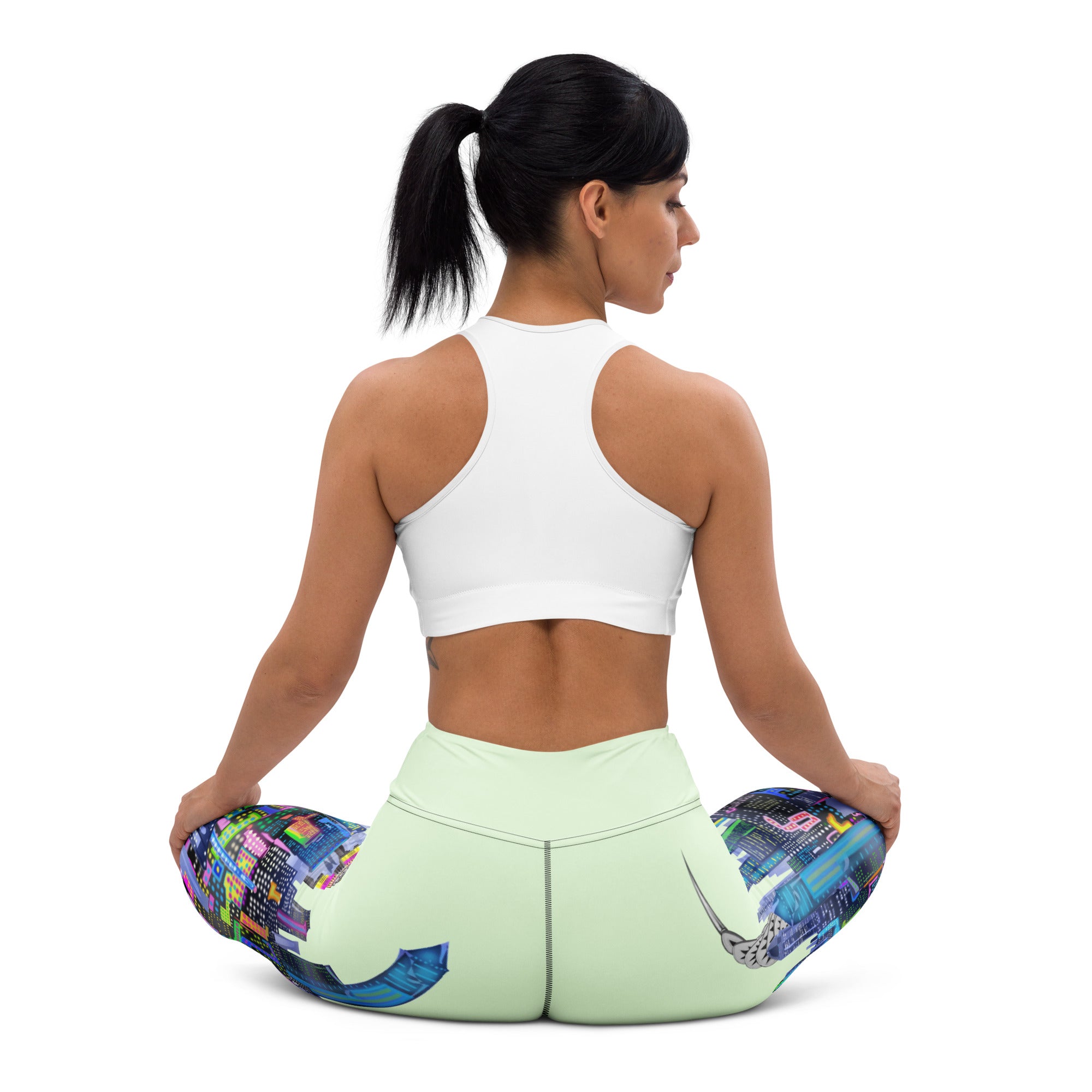 Woman sitting on a Loria NYC Art colorful yoga cushion with a white background