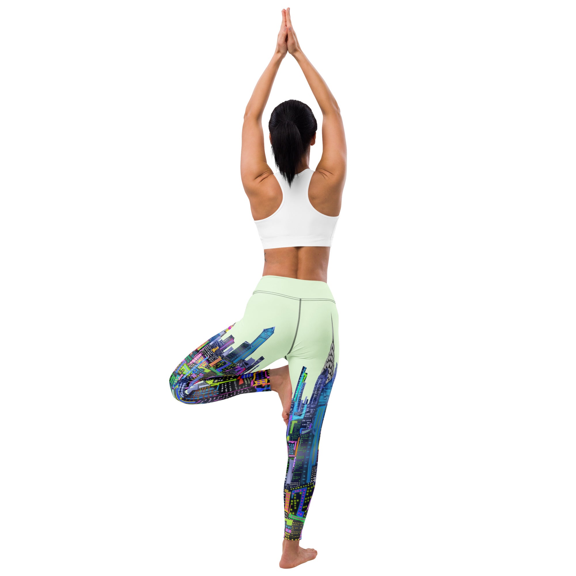 Person wearing colorful leggings with a Loria NYC Art cityscape design on a white background
