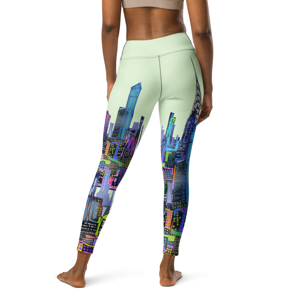 Rear view of Loria NYC Art green Leggings with colorful cityscape design on a white background