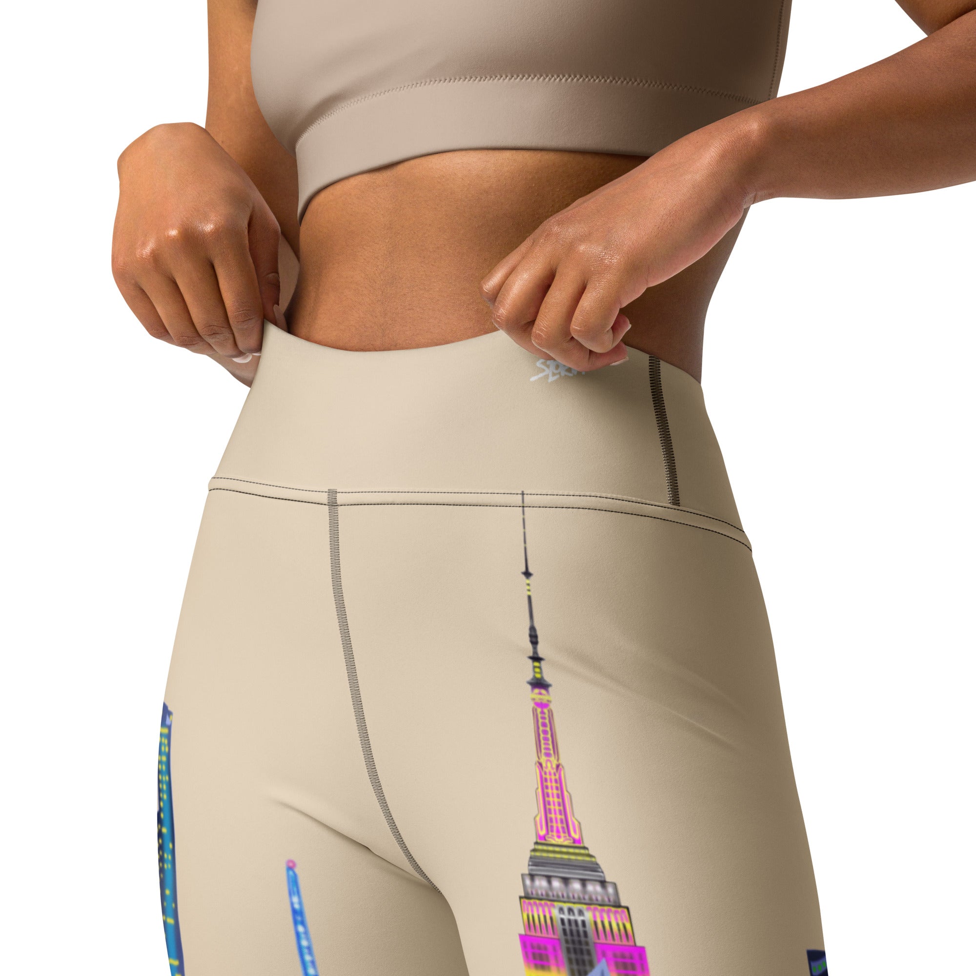 Beige Loria NYC Art leggings with colorful Empire State Building design on a white background