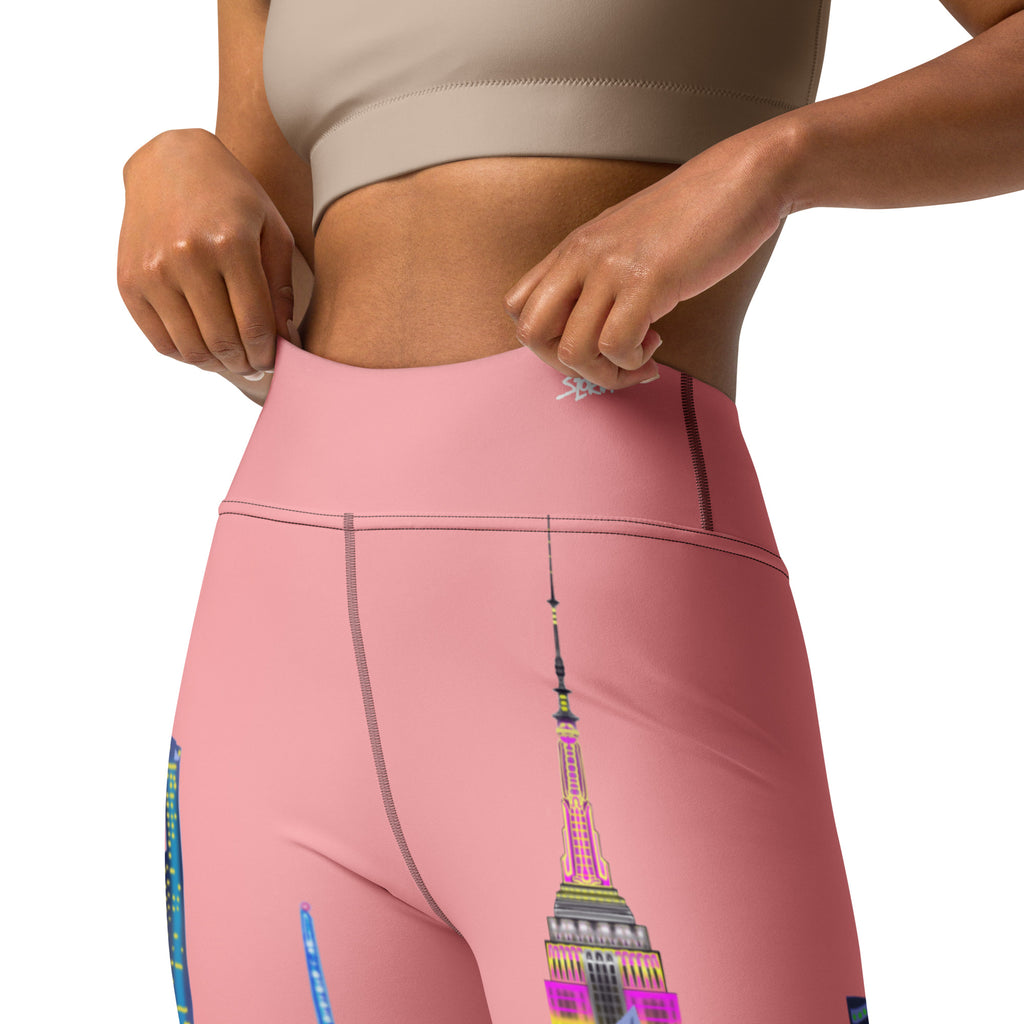 Person wearing pink leggings with a colorful Loria NYC Art design on a white background