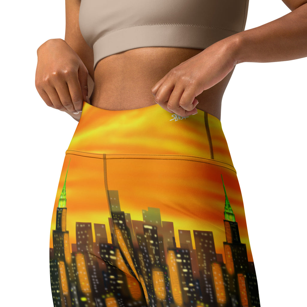 Person wearing leggings with a Loria NYC Art cityscape design at sunset.