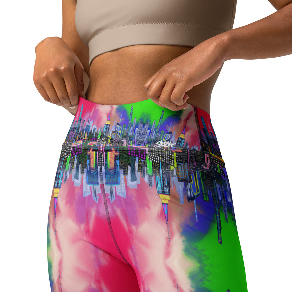 Multicolored tie-dye leggings designed by Loria NYC Art and worn by a person on a white background