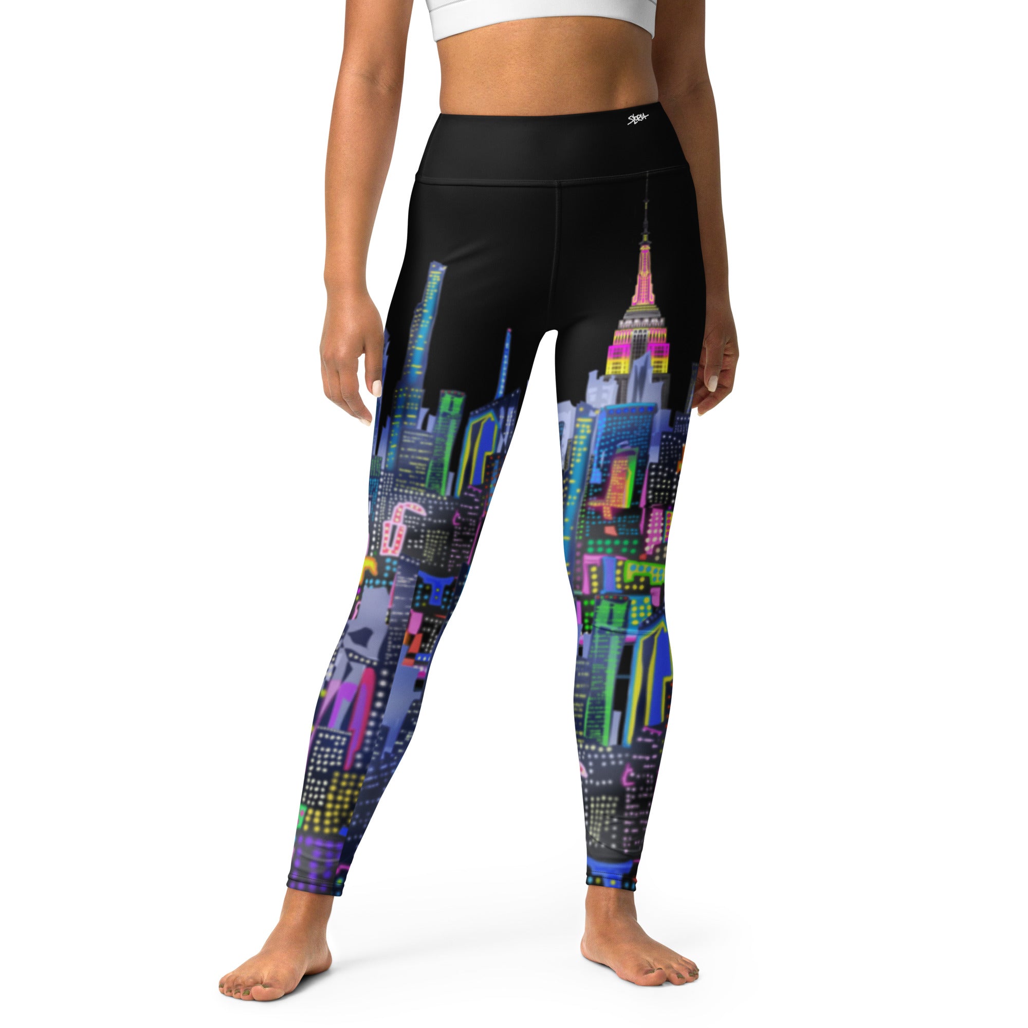 Leggings with colorful  Loria NYC Art cityscape design worn by a person on a white background
