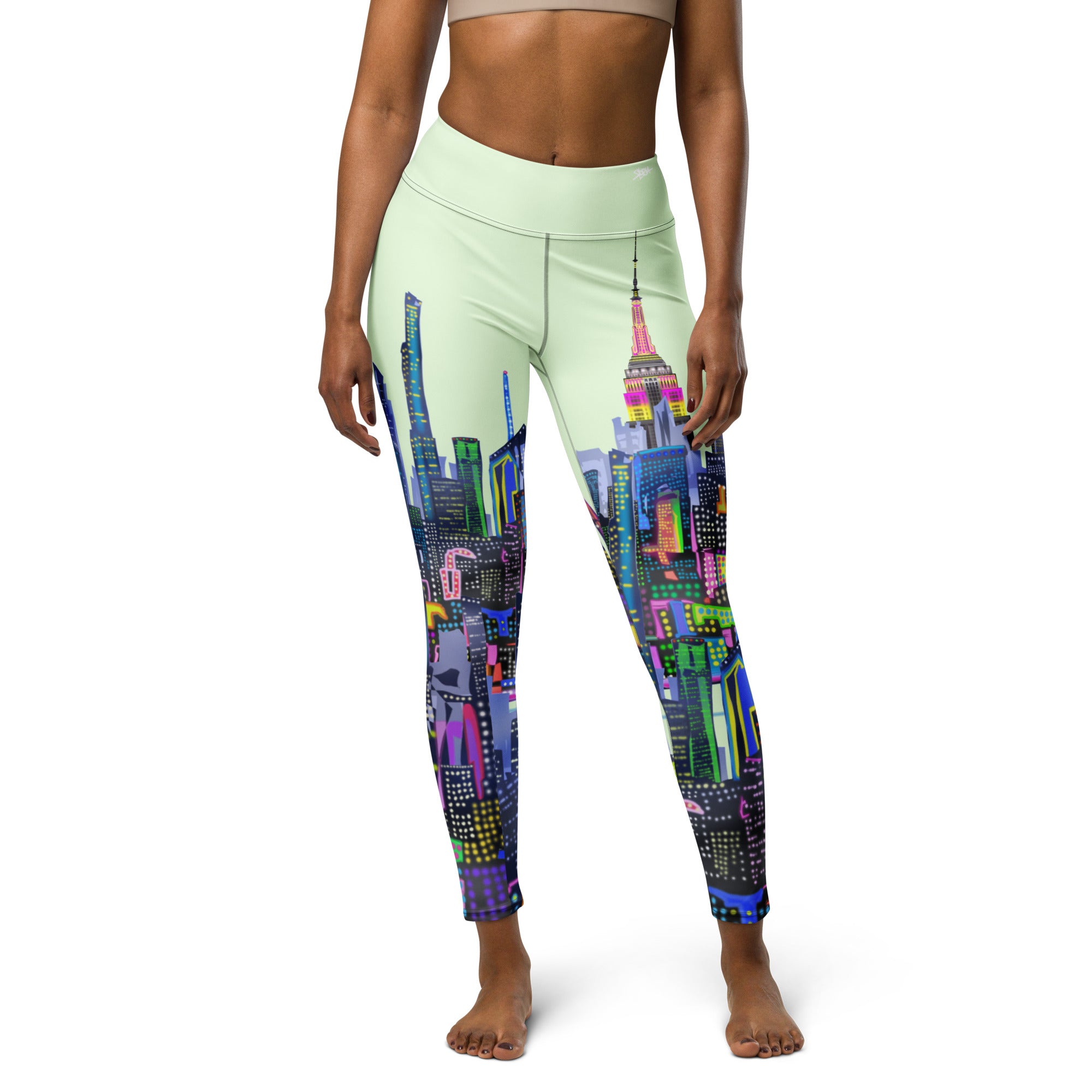 Leggings with colorful cityscape design by Loria NYC Art on a white background