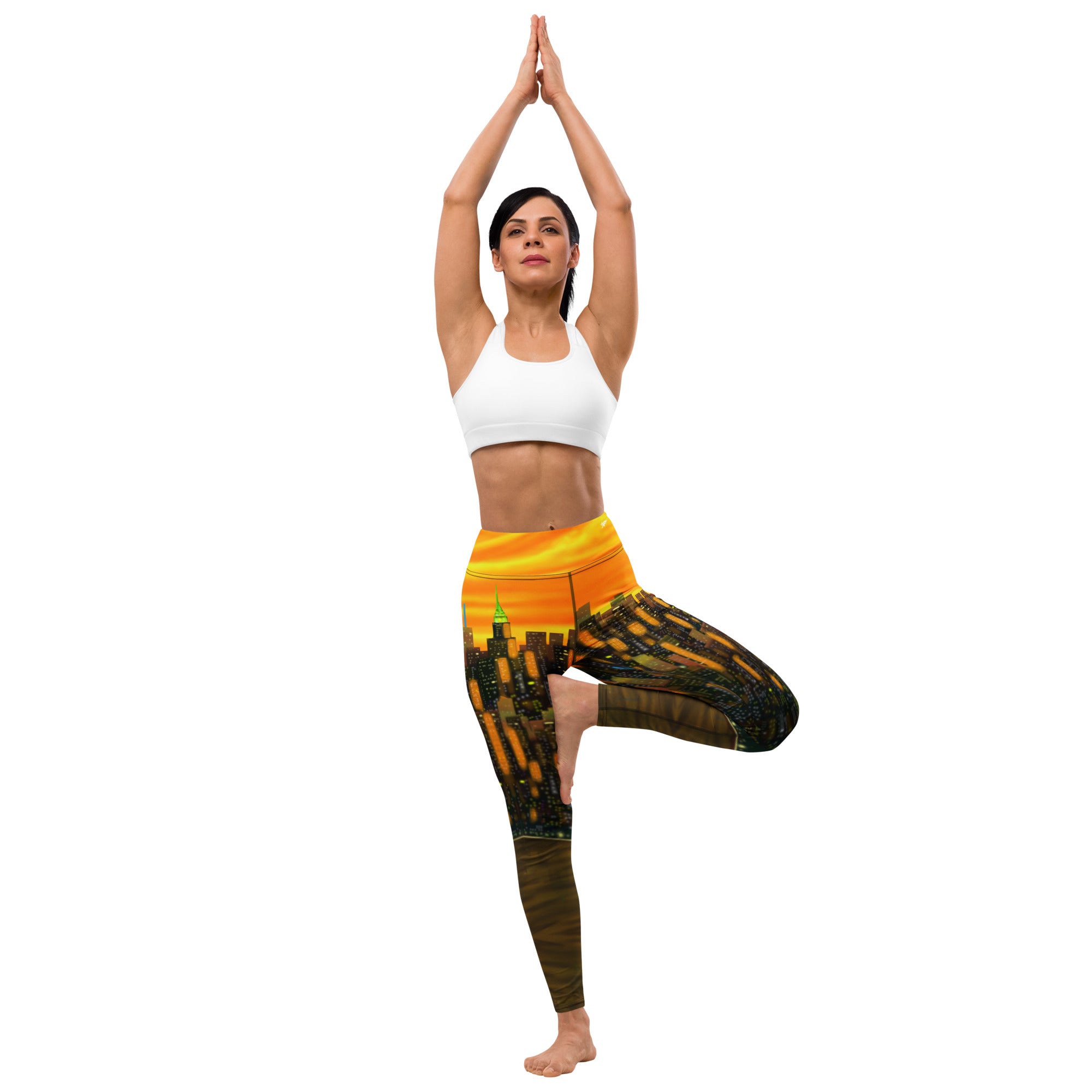 Woman in a yoga pose wearing a white sports bra and Loria NYC Art colorful leggings on a white background