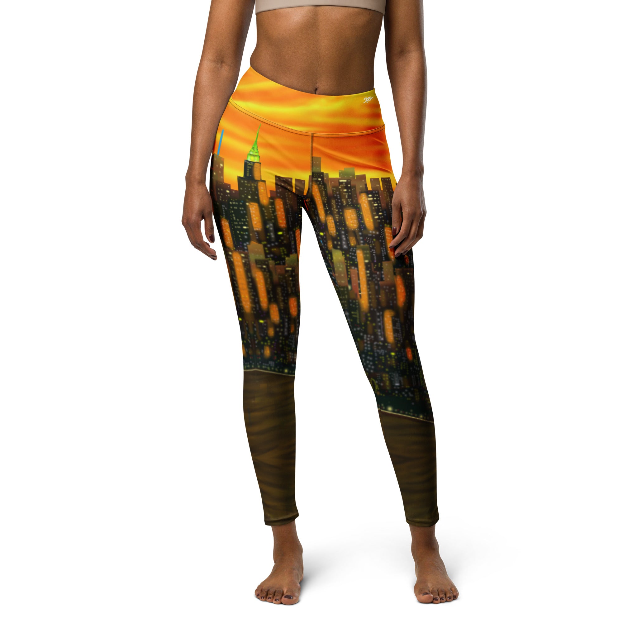 Orange Leggings with a cityscape Loria NYC Art design on a white background