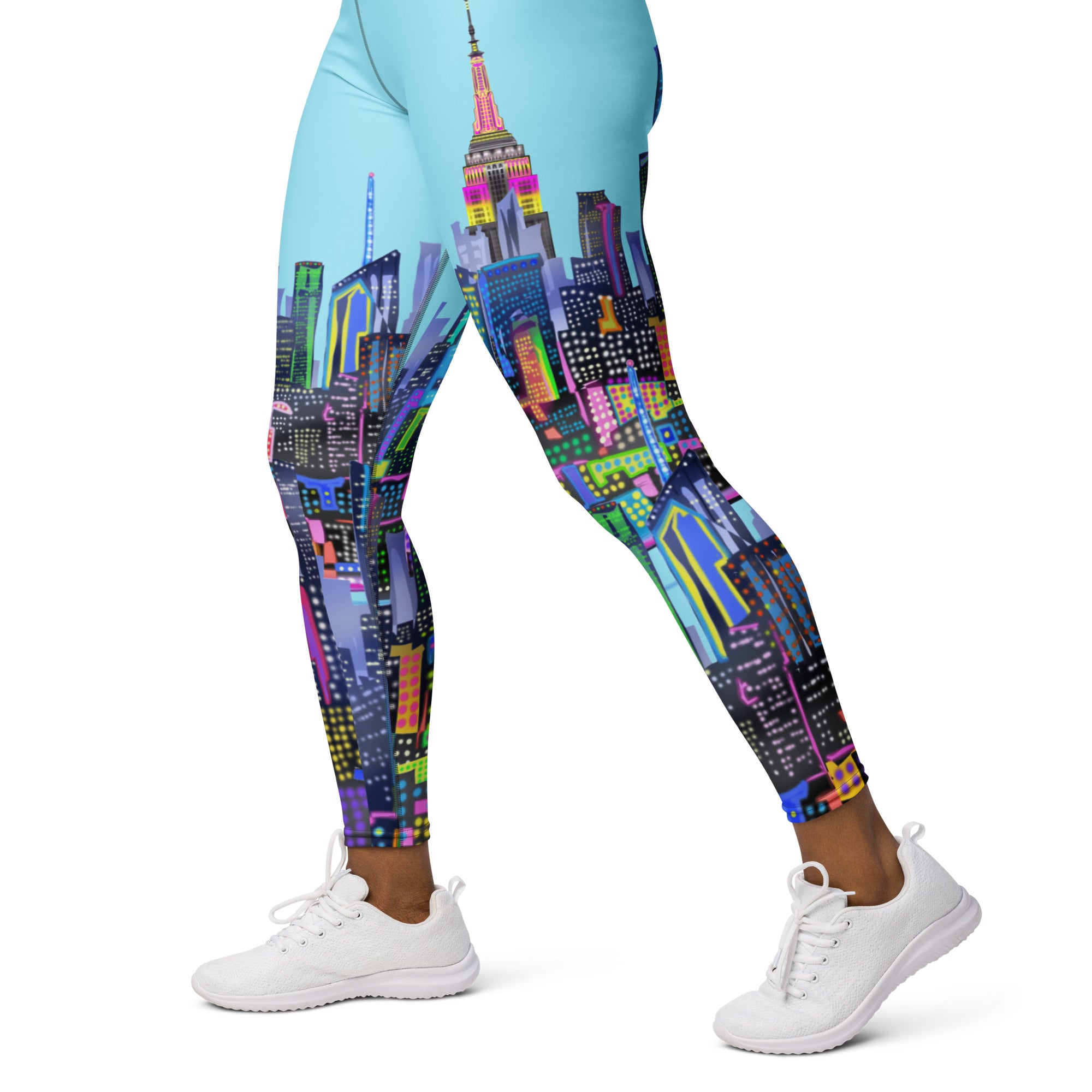 Leggings with a colorful cityscape Loria NYC Art design worn by a person on a white background