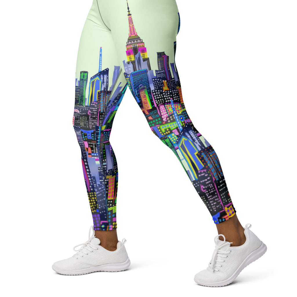 Leggings with a colorful Loria NYC Art  cityscape design worn by a person on a white background