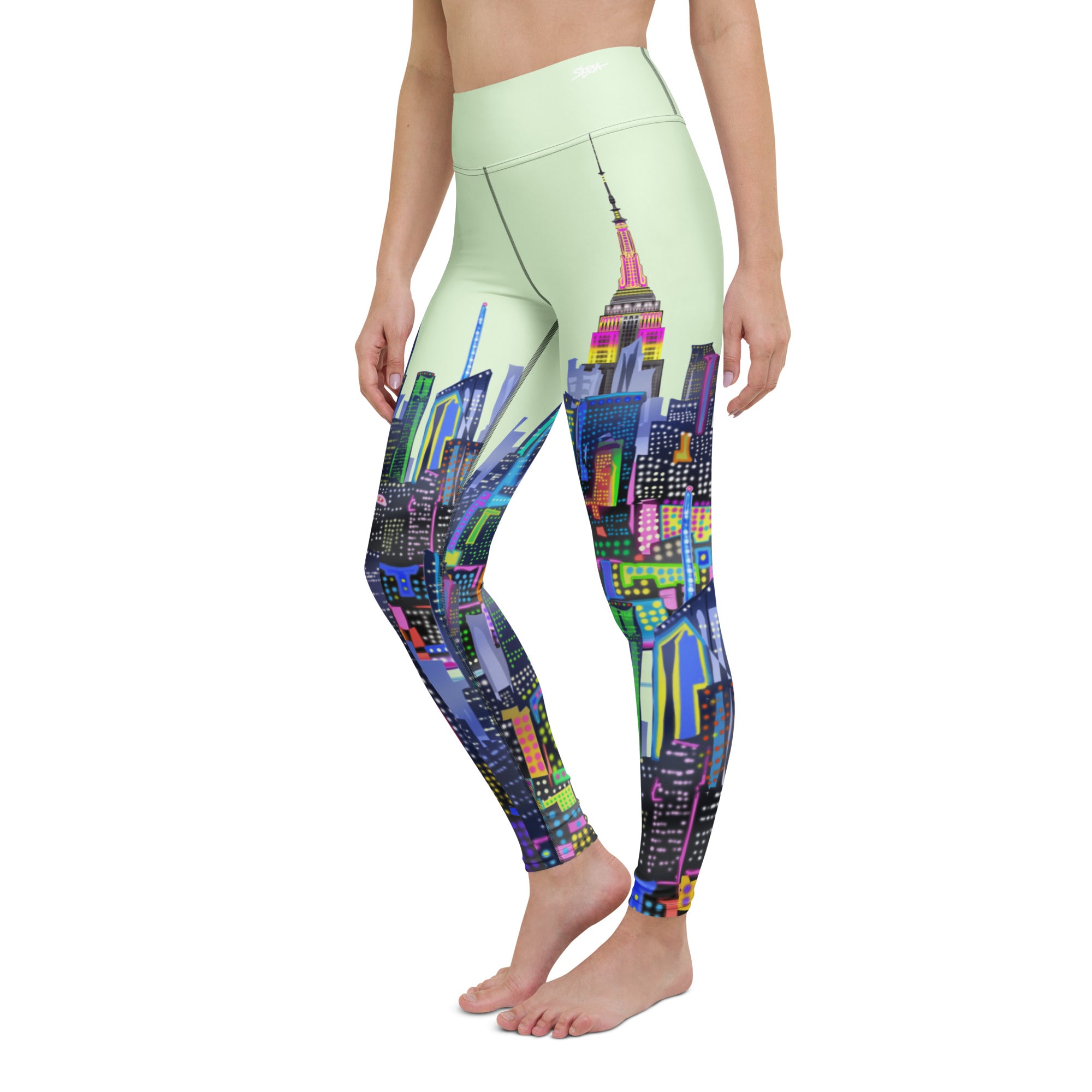 Leggings with colorful cityscape design by Loria NYC Art worn by a person on a white background
