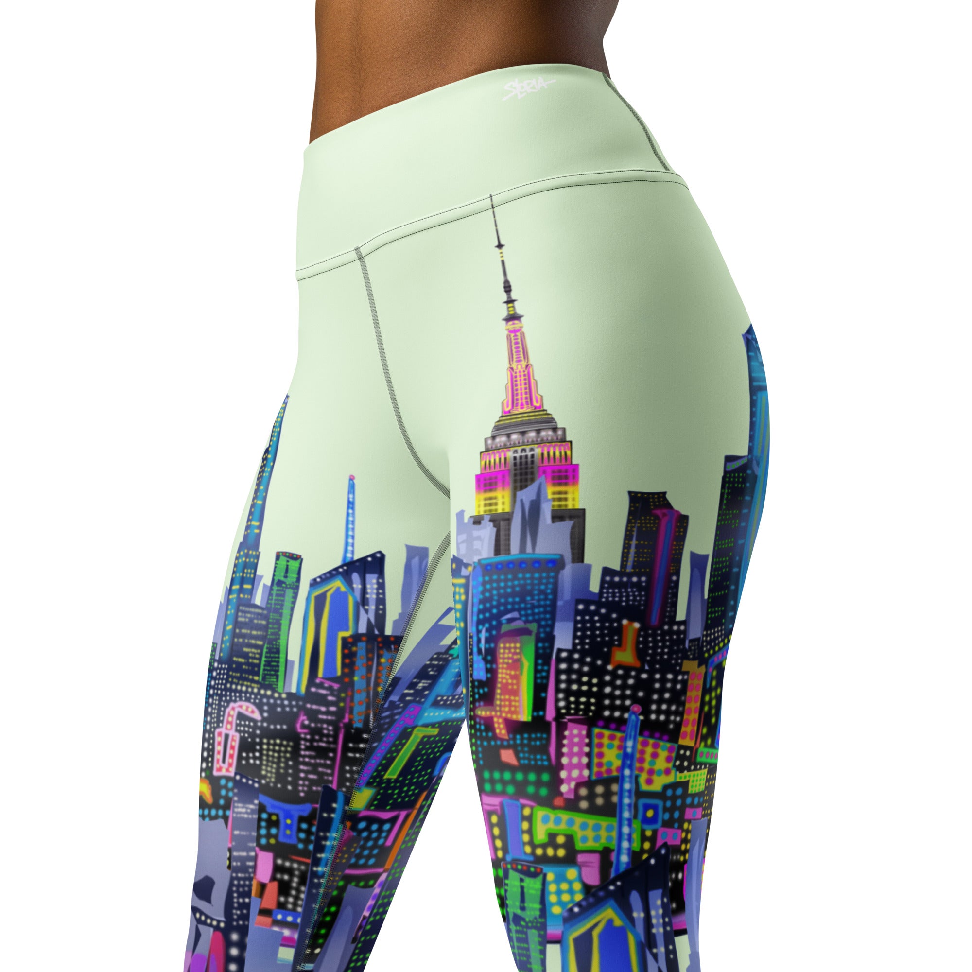 Leggings with a green colorful Loria NYC Art cityscape design on a light green background