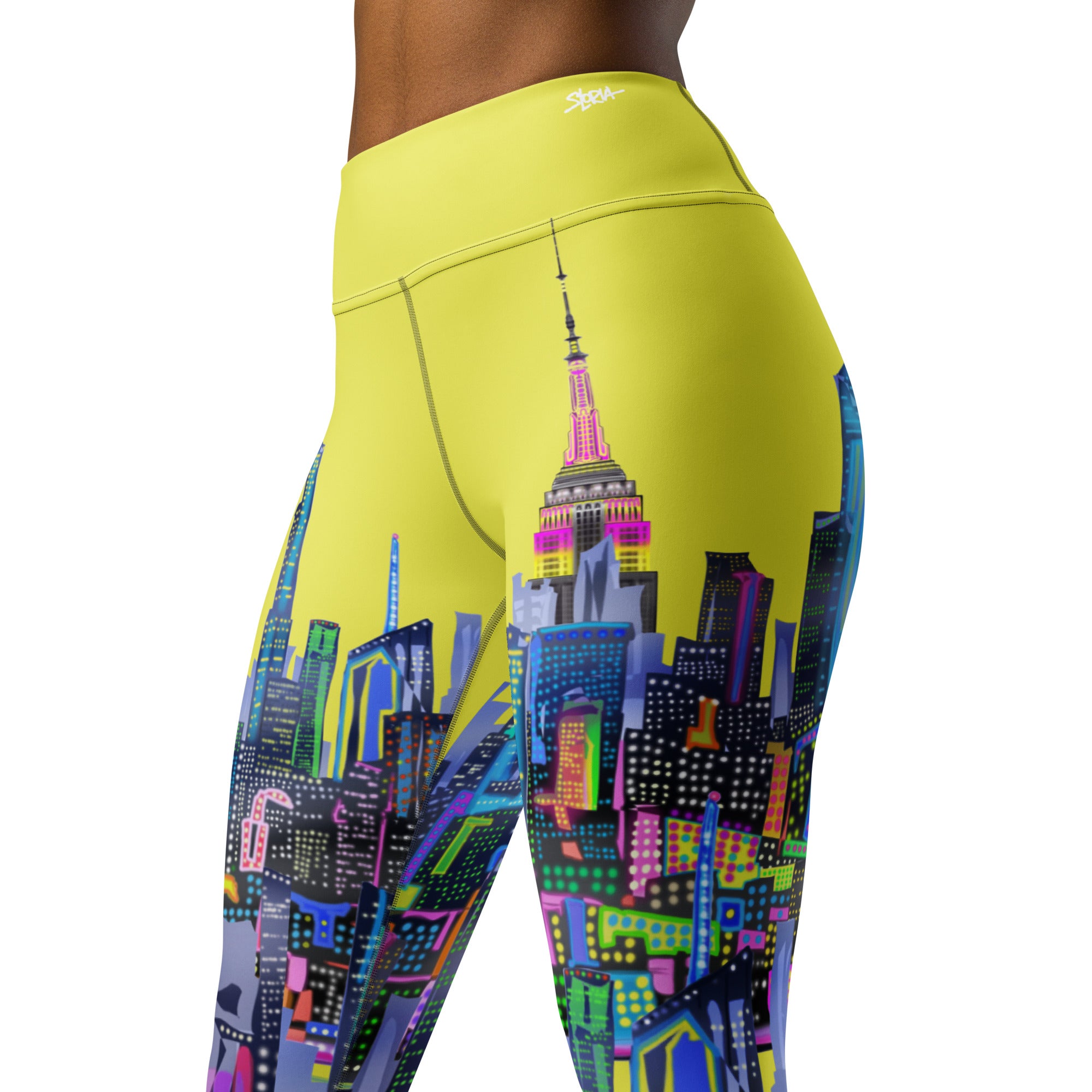 Yellow leggings with colorful Loria NYC Art cityscape design on a white background