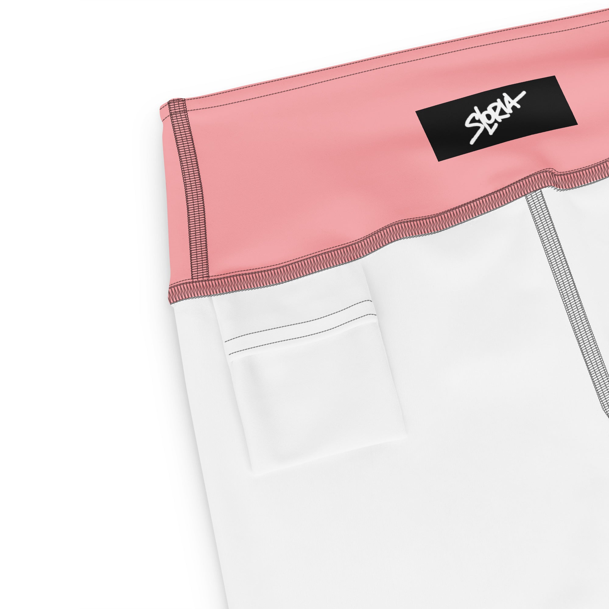 Close-up of a white athletic outfit with pink waistband and brand S.Loria logo on a white background