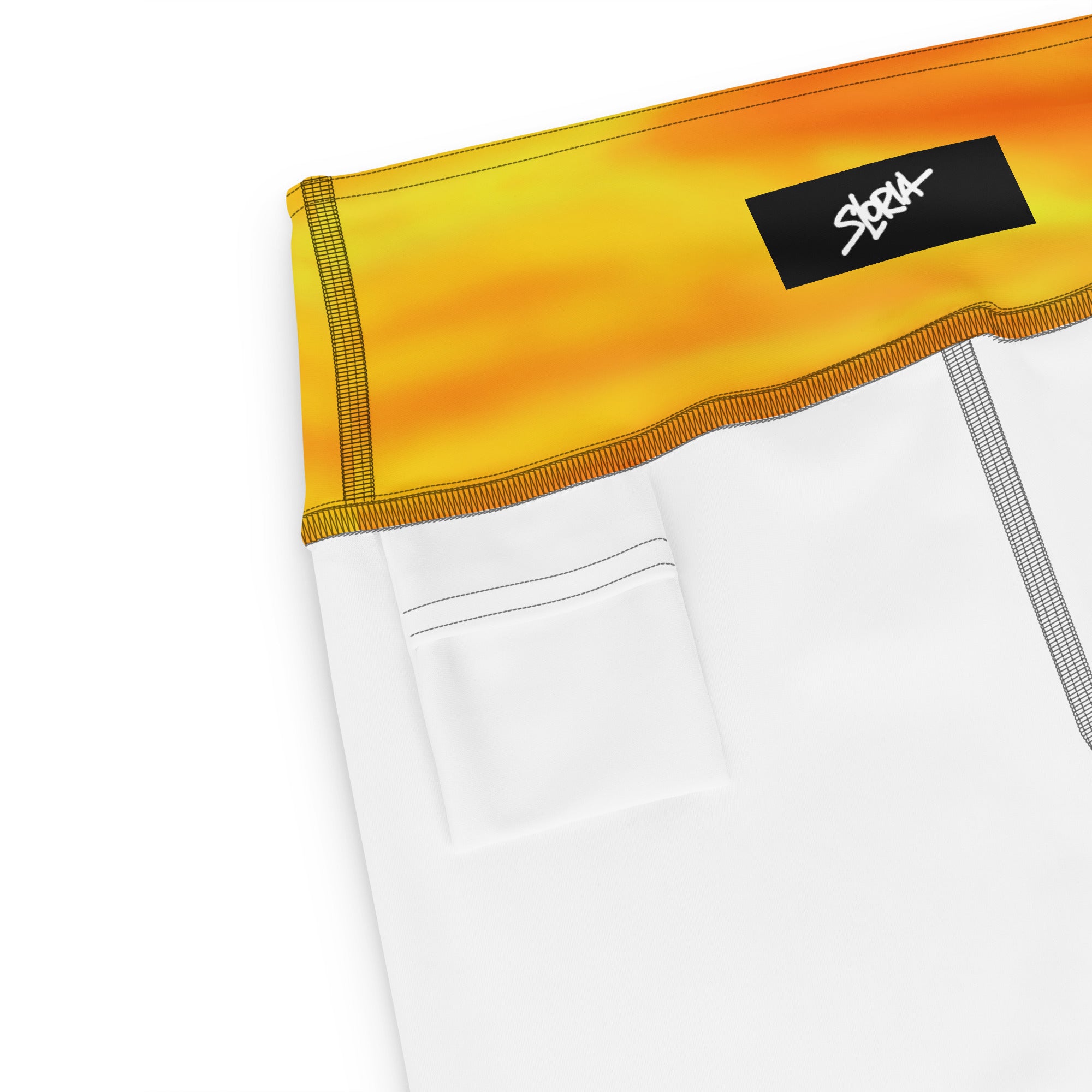 Close-up of a white garment with a yellow band featuring a S.Loria logo on a white background