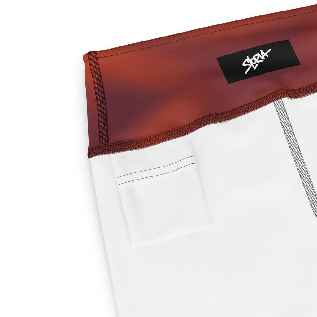 Close-up of a white garment with red trim and a black Loria NYC Art label on a white background