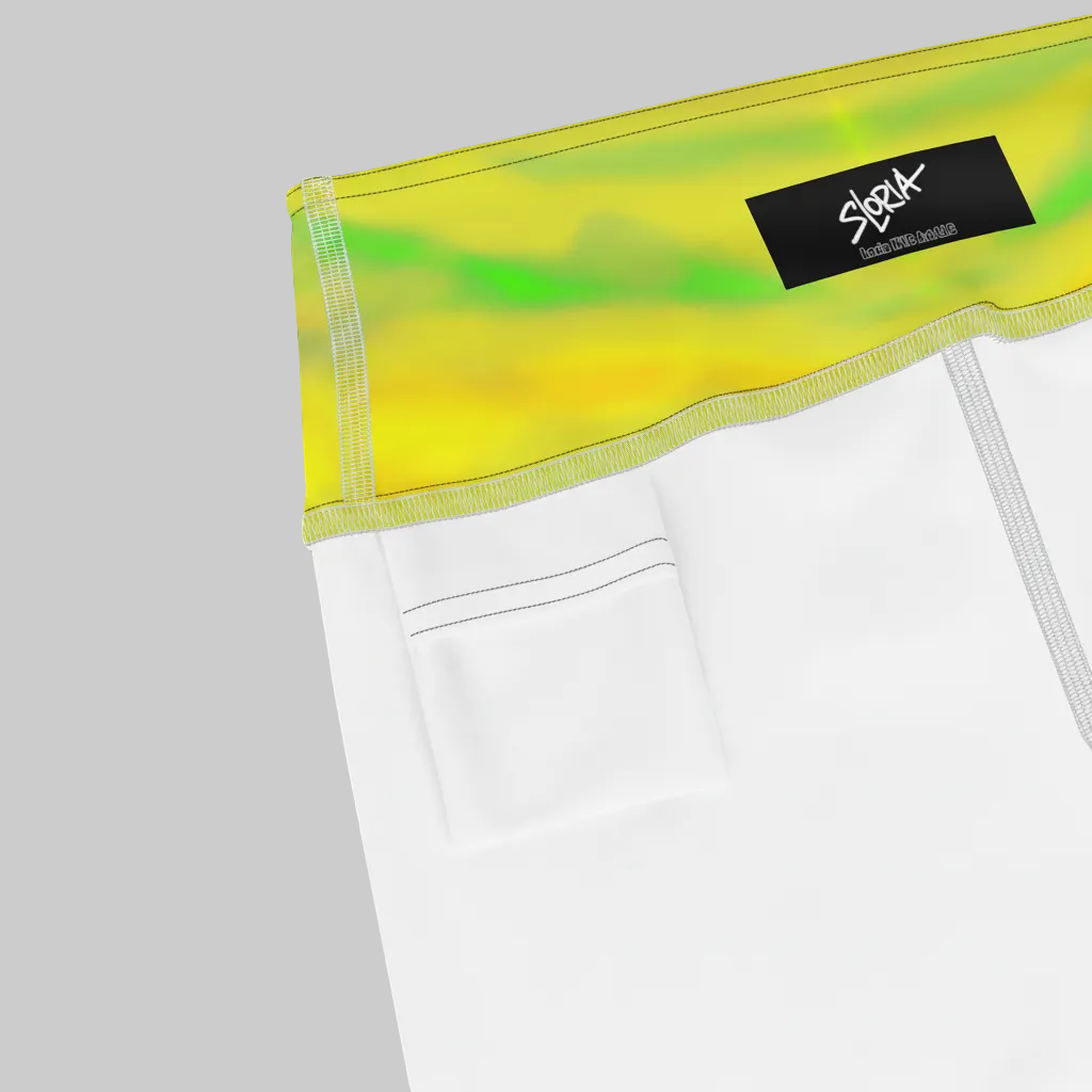 Close-up of a white garment with a yellow and green Loria NYC Art leggings featuring a brand logo on a white background.