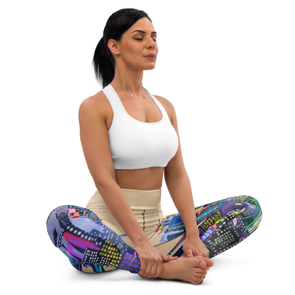 Woman in a yoga pose wearing colorful Loria NYC Art leggings and a white sports bra on a white background