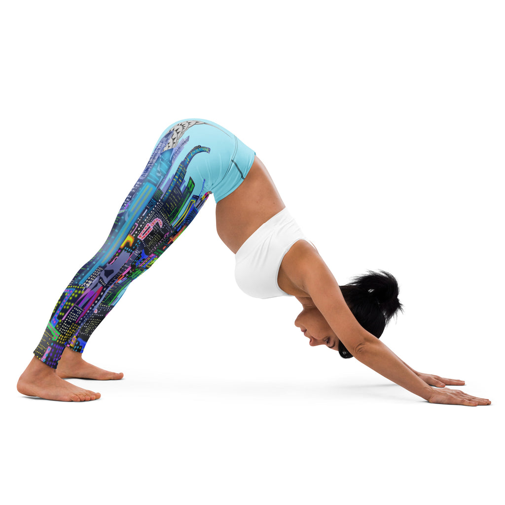 Person wearing colorful Loria NYC Art leggings and a white top, performing a yoga pose on a white background