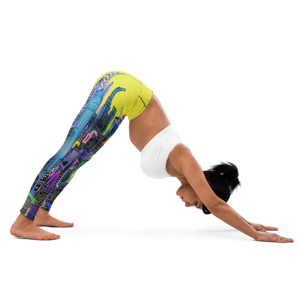 Person wearing colorful leggings with a cityscape Loria NYC Art design and white top, performing a yoga pose on a white background.