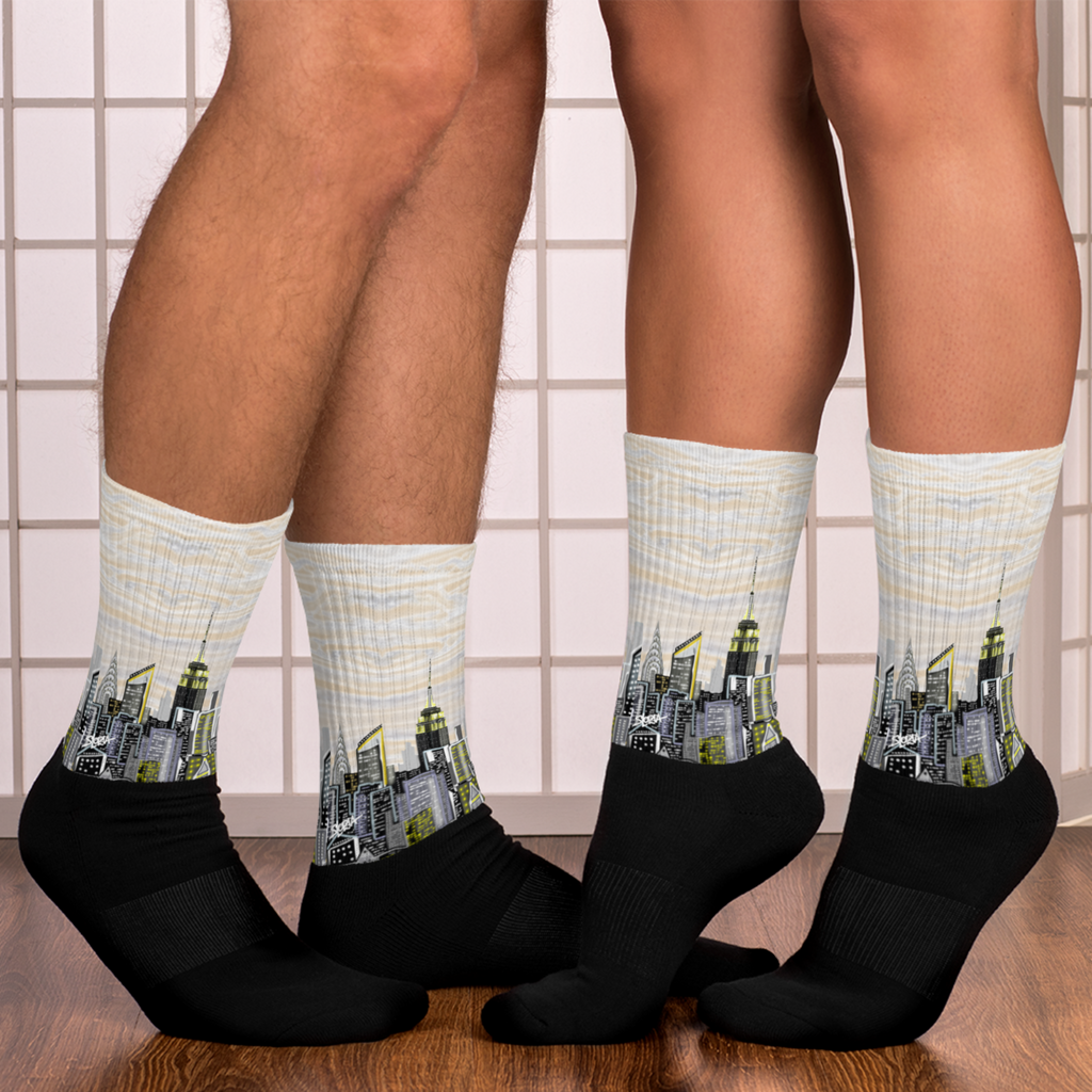 Loria NYC Art Cityscape socks worn by two people on a tiled floor.