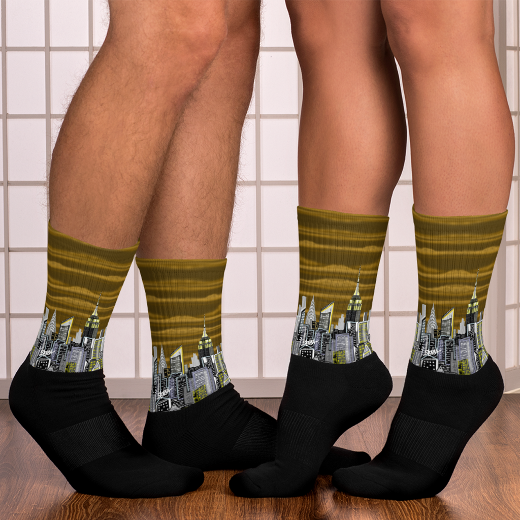 Person wearing socks with Loria NYC Art cityscape design on a tiled floor