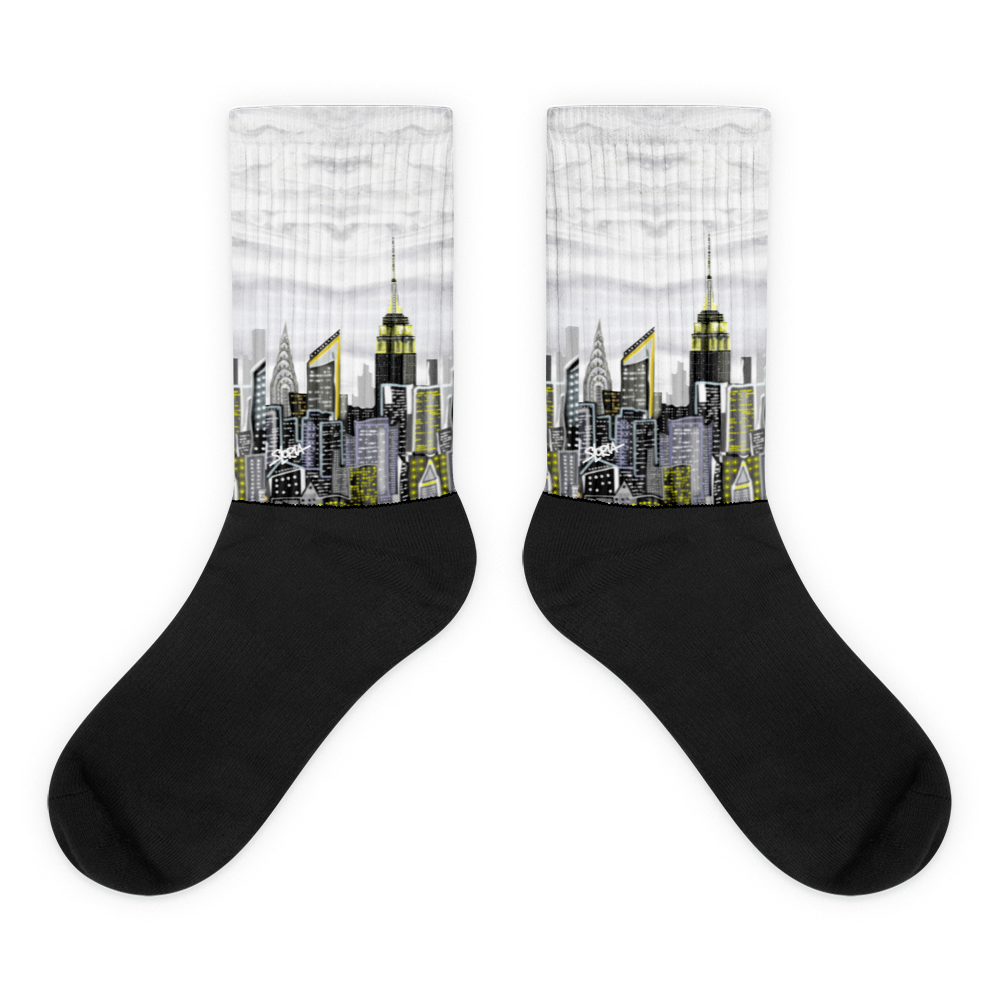 Black Loria NYC Art socks with city skyline design on a white background