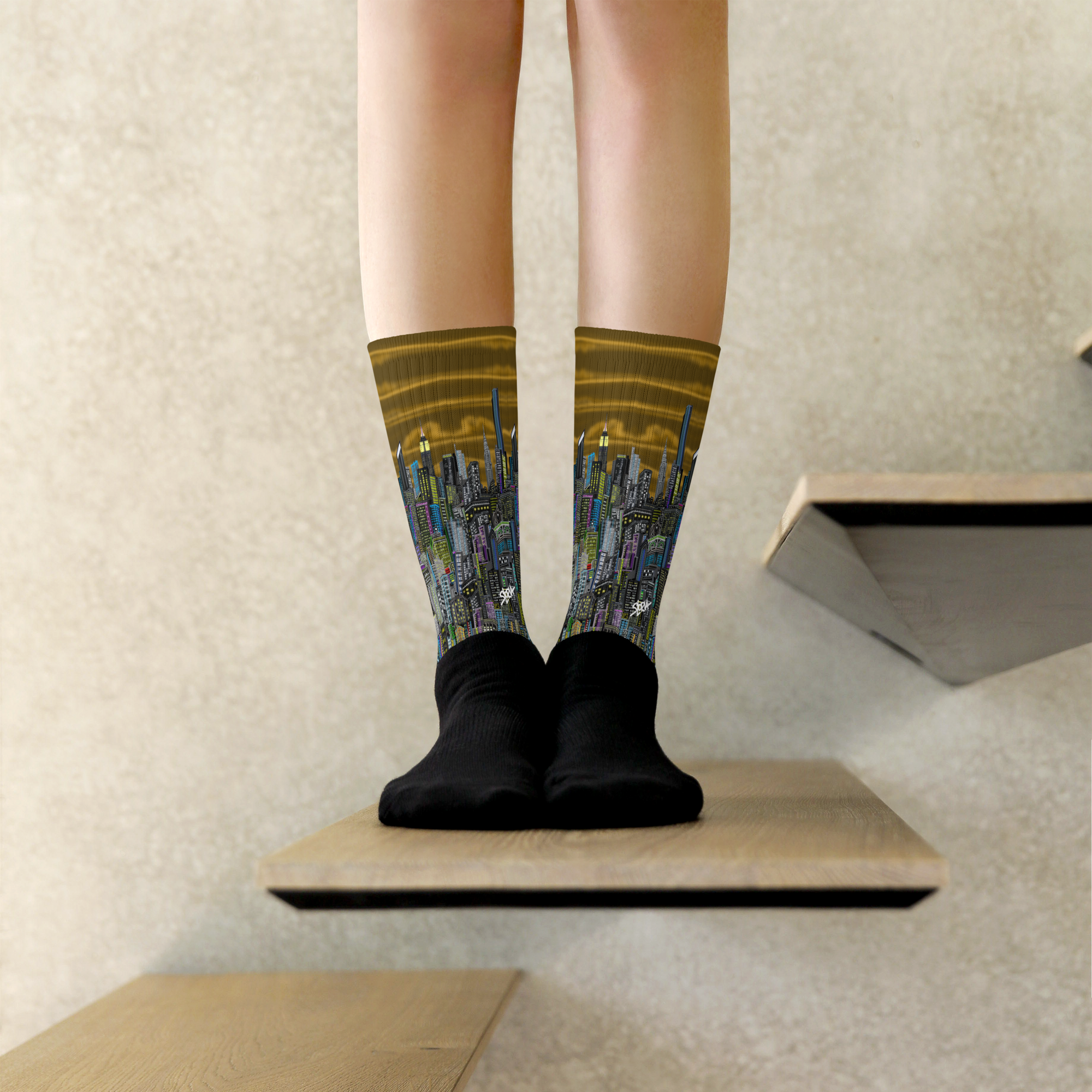 Person wearing socks with a Loria NYC Art cityscape design on a neutral background