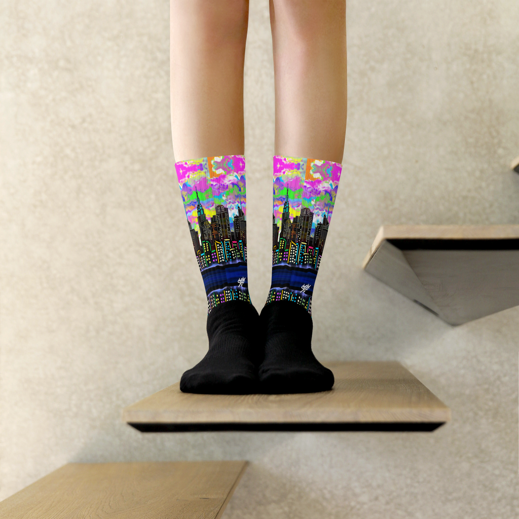 Colorful cityscape Loria NYC Art socks worn by a person on a neutral background